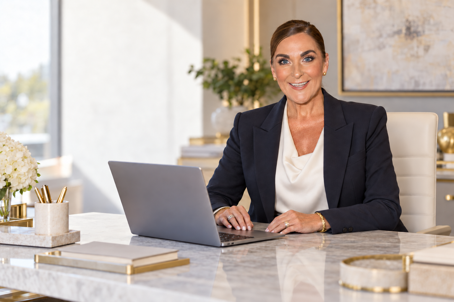 Caroline Downey seated at her desk in a bright creative office